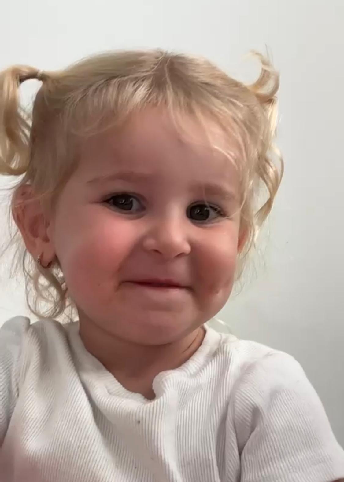 Atarah Nava with pigtails, smiling softly
