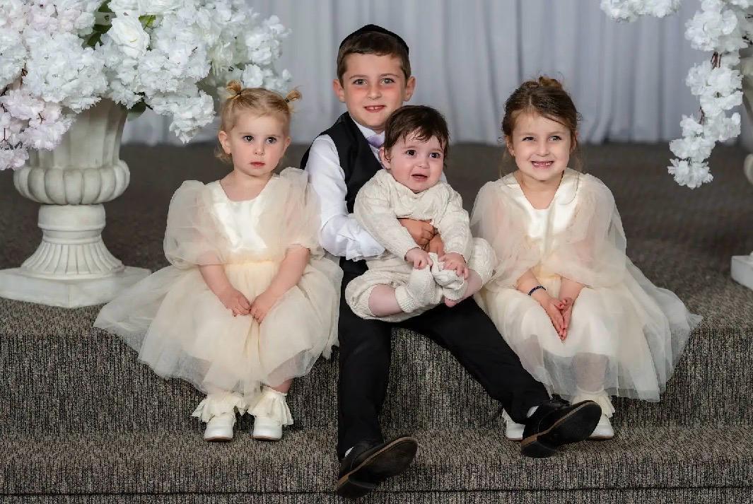 The Weiss kids dressed up and sitting together