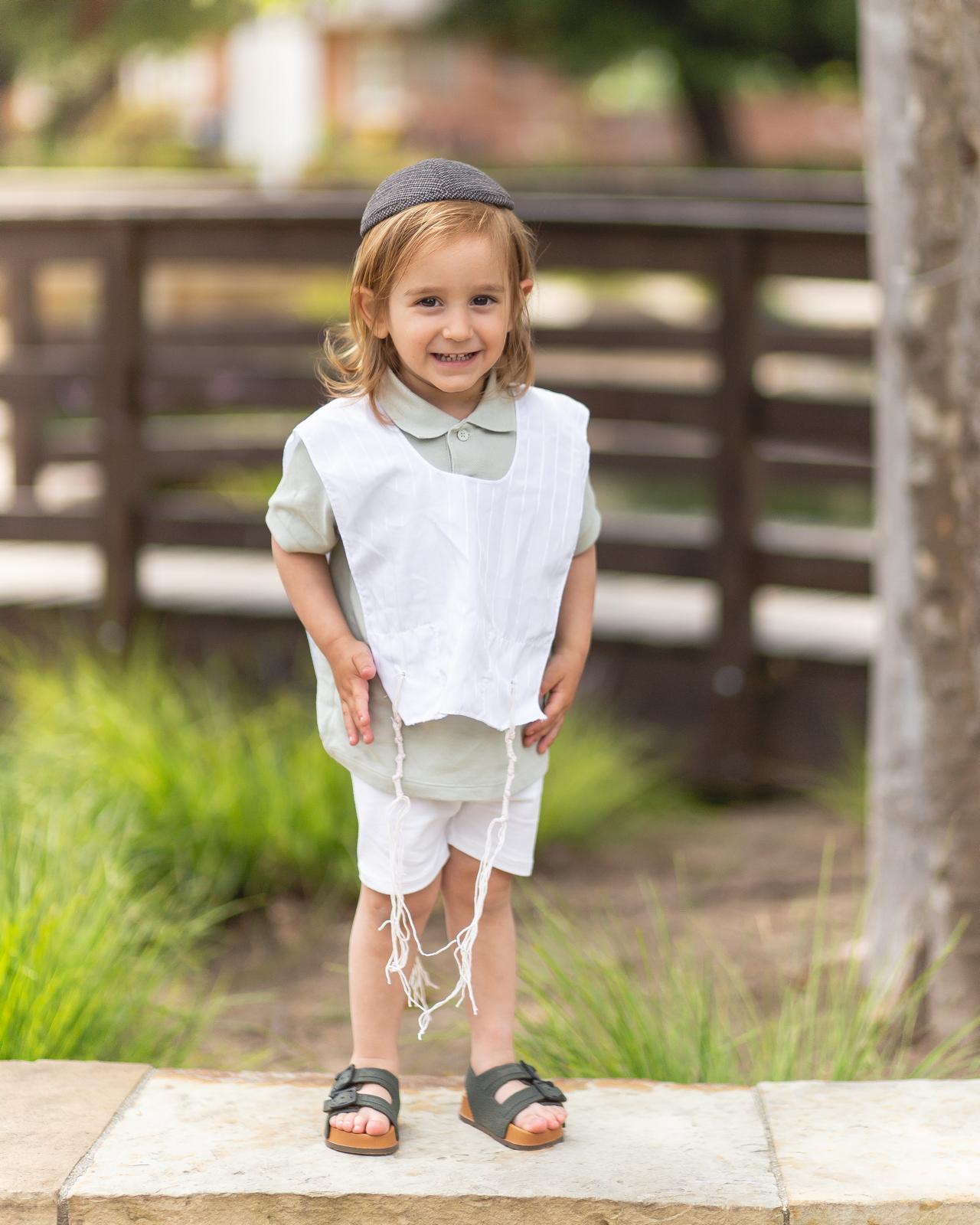 Daniel Meir standing outdoors in white